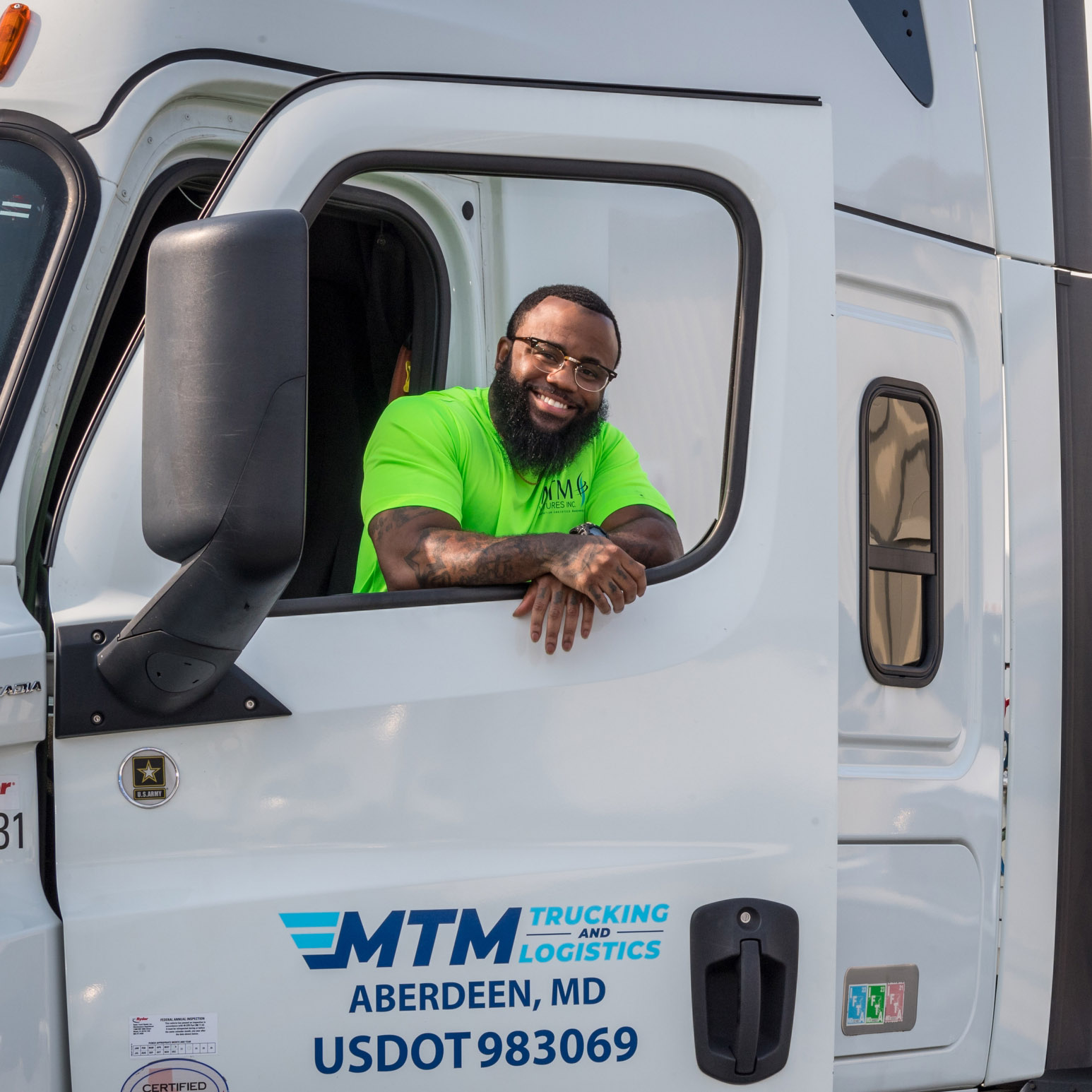 An MTM trucker looks through the window of a truck